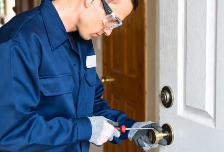 a locksmith using hardware for repairing